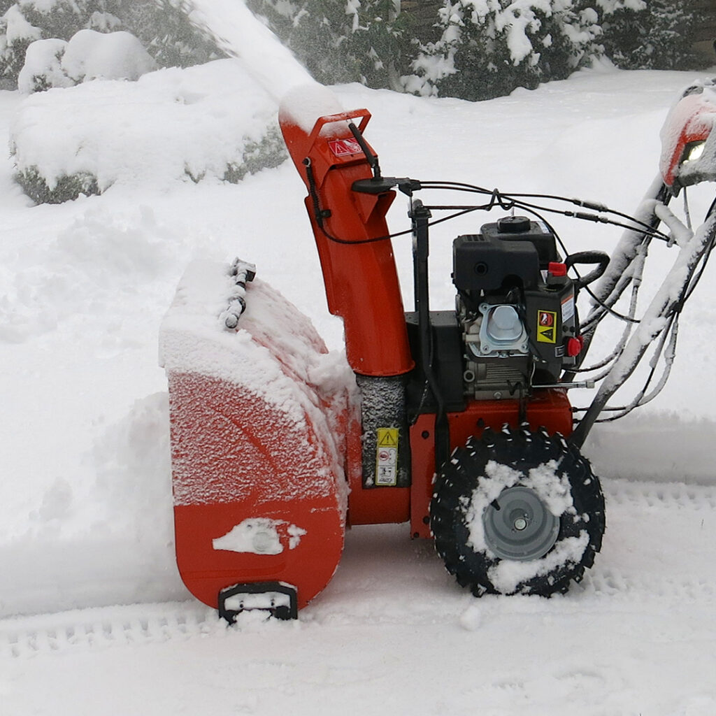 Image of a snow blower shooting snow from the top